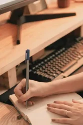person-writing-in-a-notebook-writing-tools-for-writers-wordista